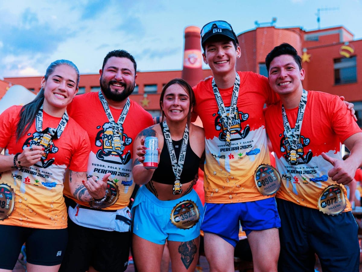 A group of friends celebrating together with finisher medals after a run